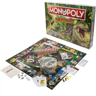 Monopoly Dinosaurs board game box featuring various dinosaur illustrations.