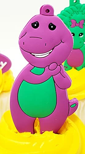 Purple dinosaur cake topper with a green belly